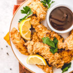 plate of paleo fried chicken with dish of BBQ sauce