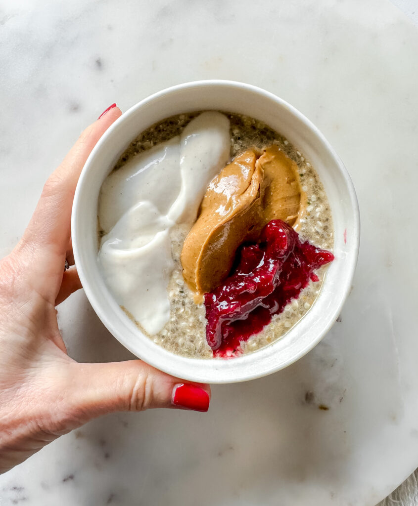 bowl of low-gi high protein NO OATS topped with peanut butter, cranberry sauce and yogurt