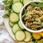 plate of cucumber rounds and a bowl of pumpkin seed dip