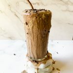 frosty glass with salted tahini smoothie spilling over sides