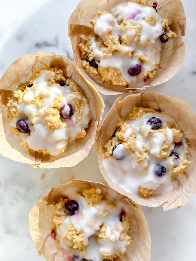 close up of lemon blueberry muffins with sugar free lemon glaze
