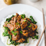 plate with bulgogi beef on a bed of spinach and konjac noodles