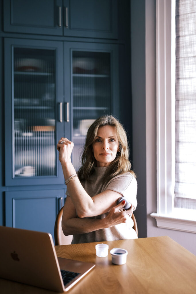 woman applying a CGM