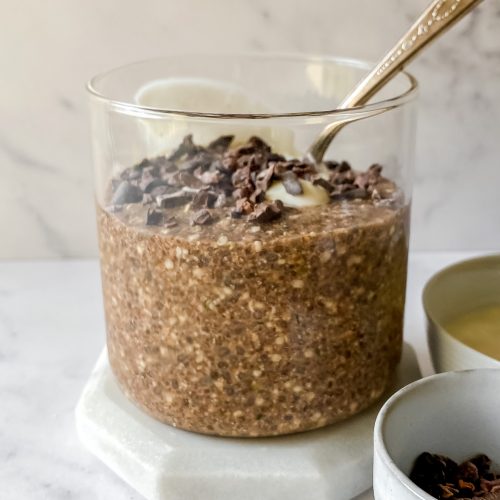 glass jar of No Oats topped with yogurt and cacao nibs