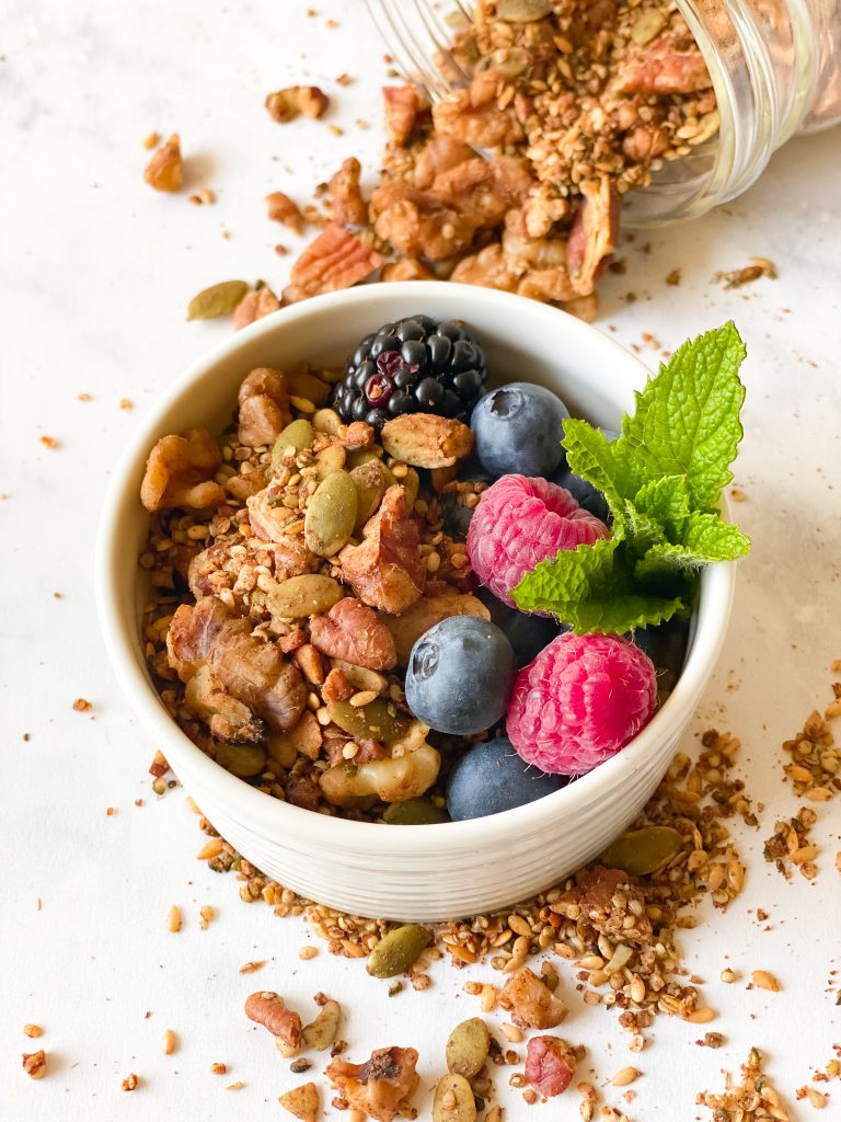 bowl of granola with berries and mint