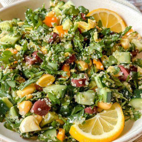close up of vibrant tabouleh salad with lemon slices