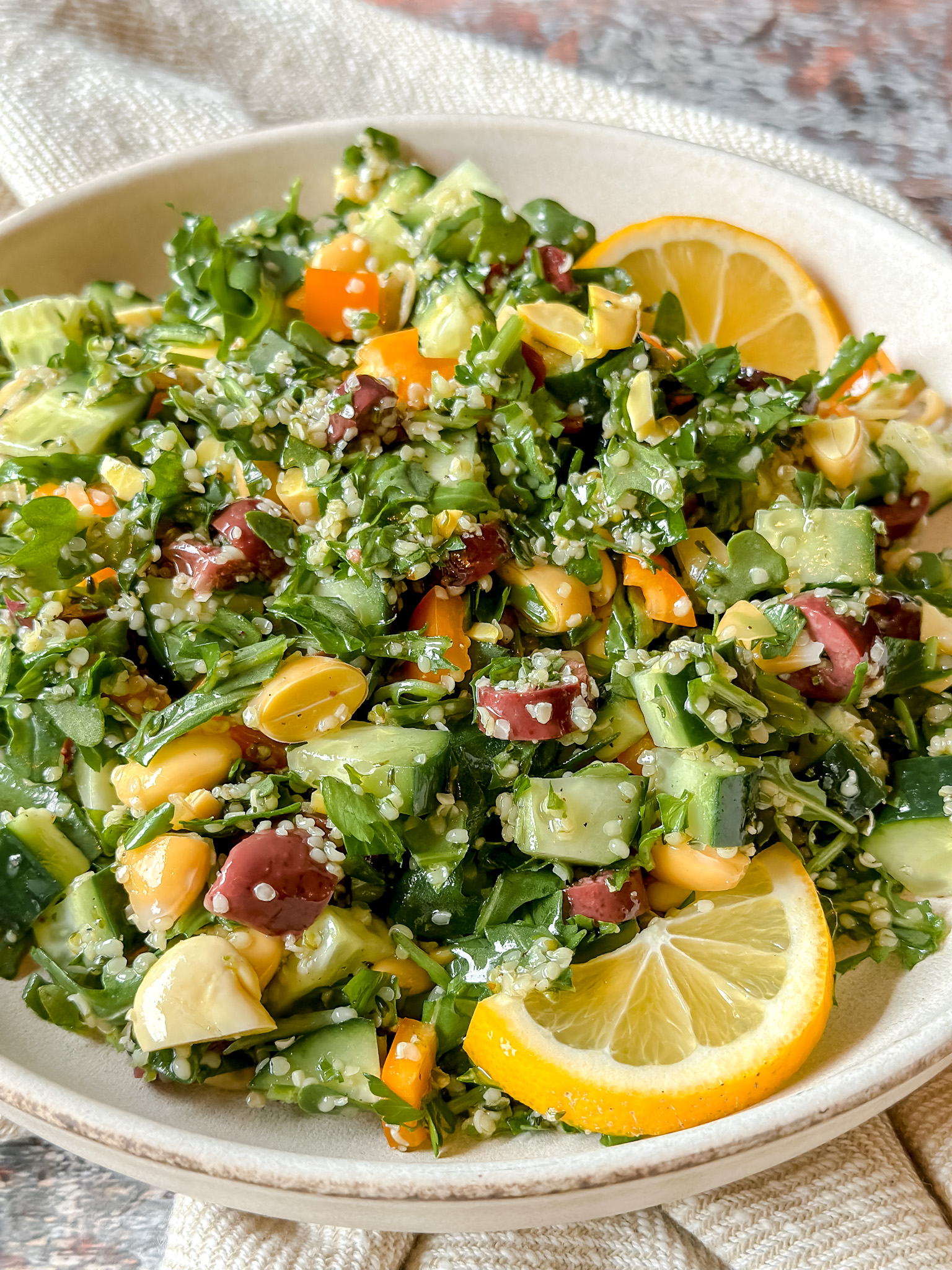 close up of vibrant tabouleh salad with lemon slices