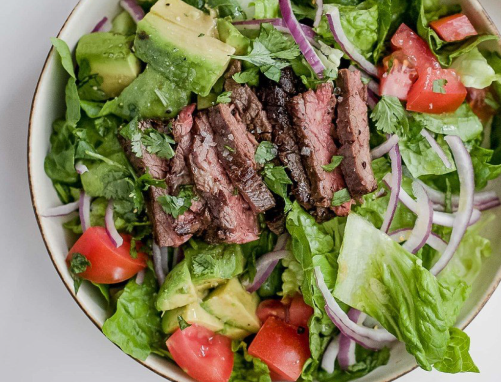 close up photo of steak and avocado salad