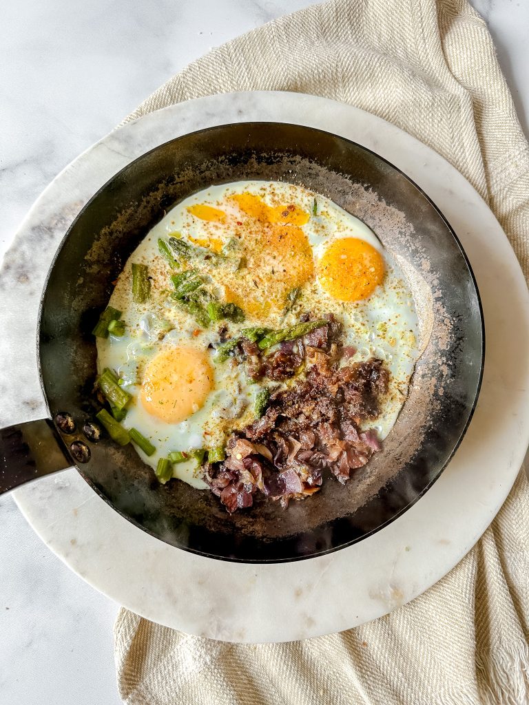 stainless steel pan with eggs and veggies