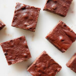 5 healthy, protein brownies on a marble backdrop